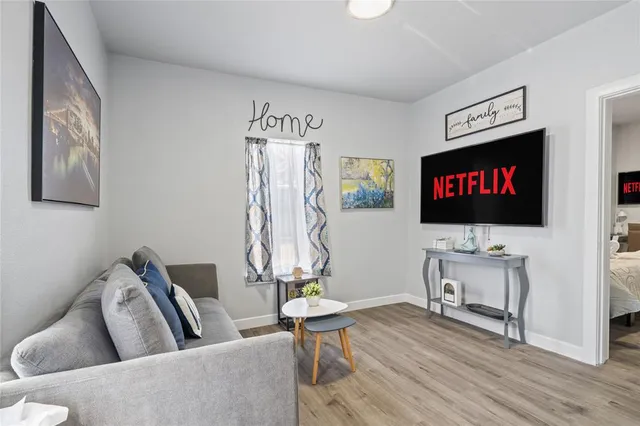 a living room with furniture and a flat screen tv