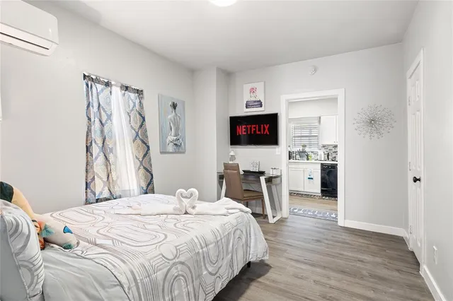 a bedroom with a bed and a flat screen tv