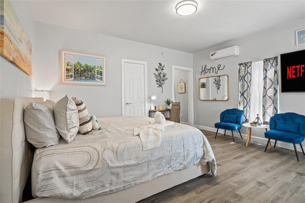 2308 Britton Avenue Dallas, TX 75216 - Photo 7 of 31 a bedroom with bed and wooden floor