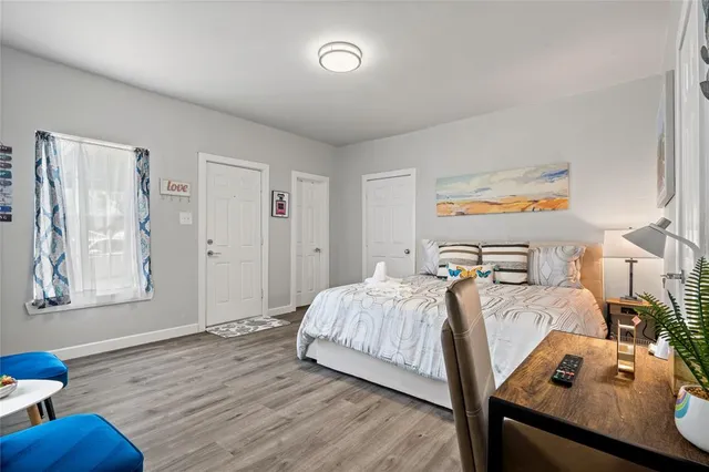 a bedroom with a bed and wooden floor