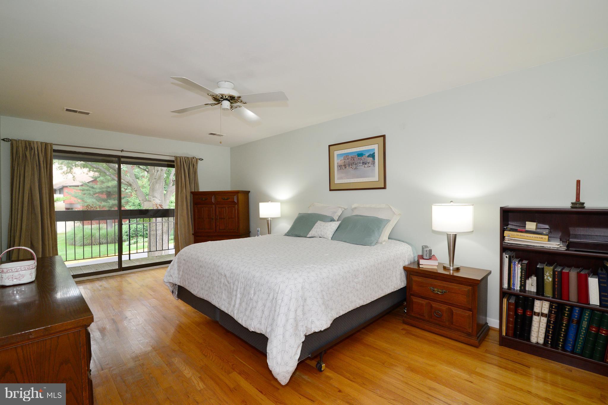 11161 Saffold Way Reston, VA 20190 - Photo 14 of 28 a bedroom with a bed furniture and a book shelf