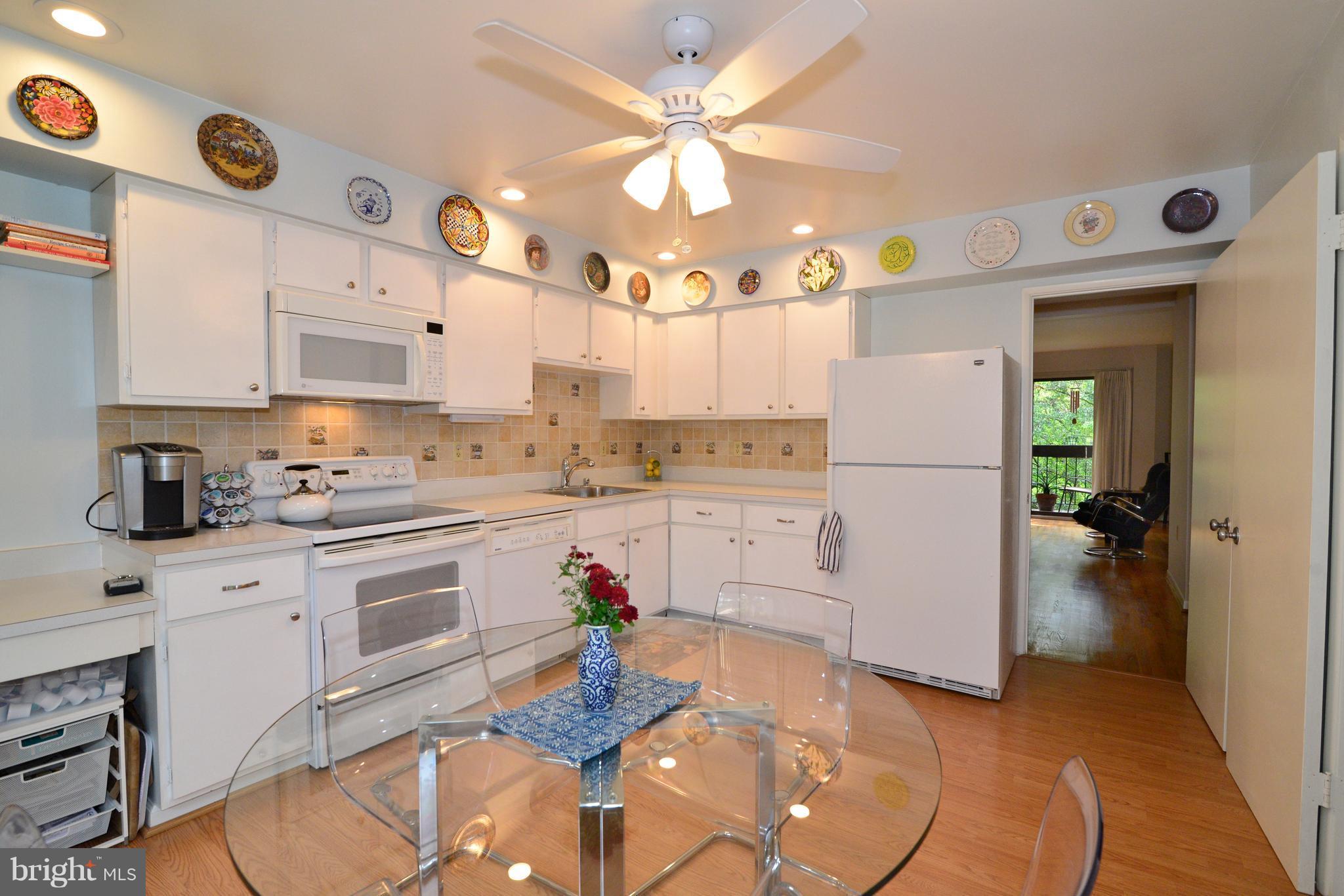 11161 Saffold Way Reston, VA 20190 - Photo 5 of 28 a open kitchen with granite countertop a sink cabinets and stainless steel appliances