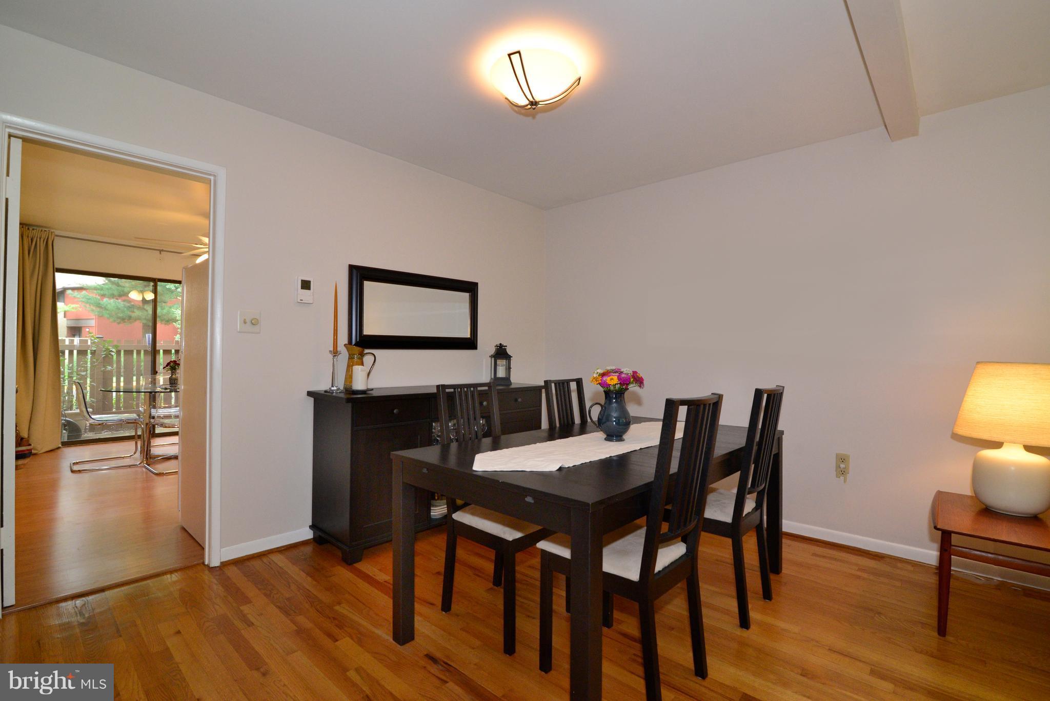 11161 Saffold Way Reston, VA 20190 - Photo 7 of 28 a view of a dining room with furniture and wooden floor