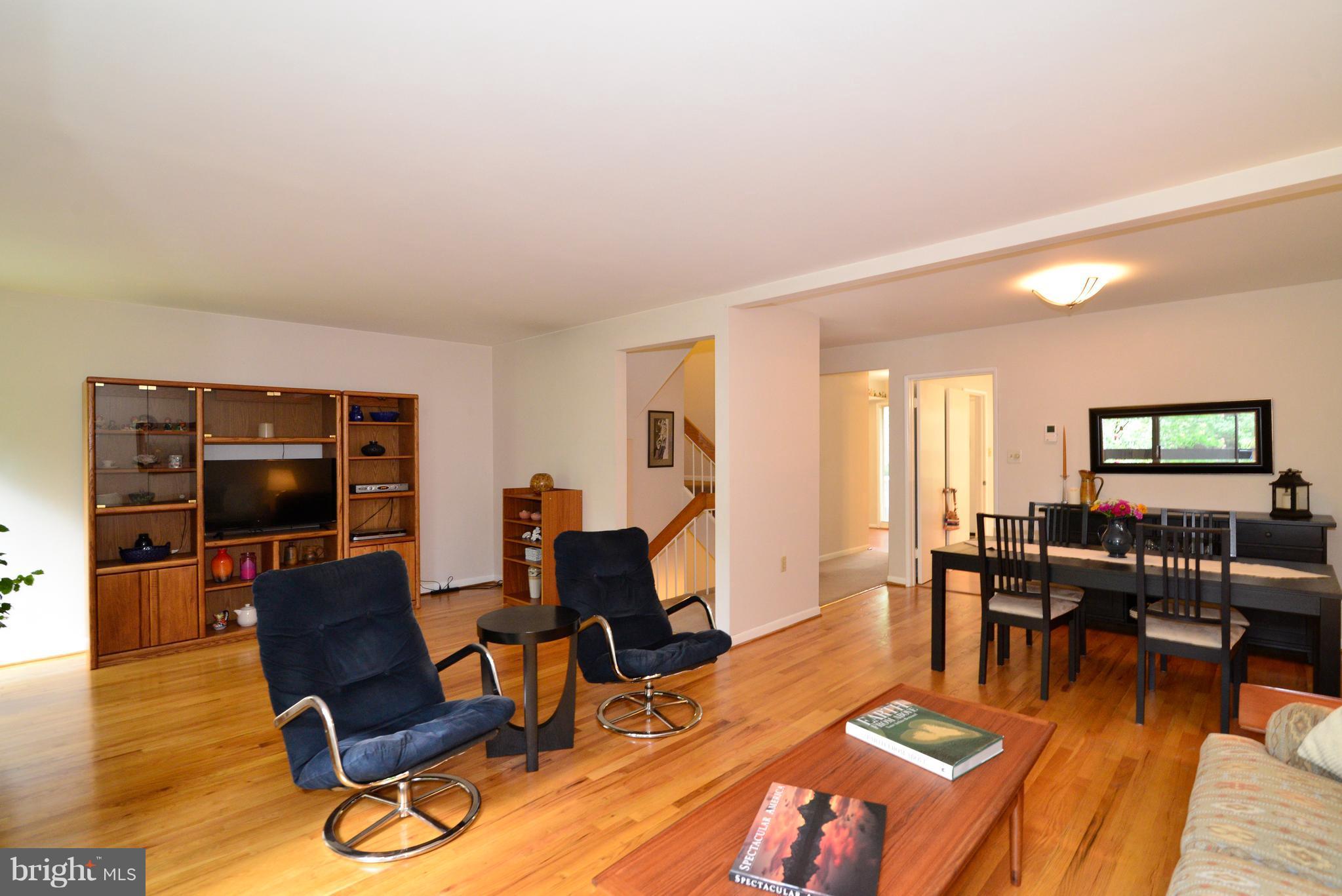 11161 Saffold Way Reston, VA 20190 - Photo 8 of 28 a living room with furniture a wooden floor and next to a window