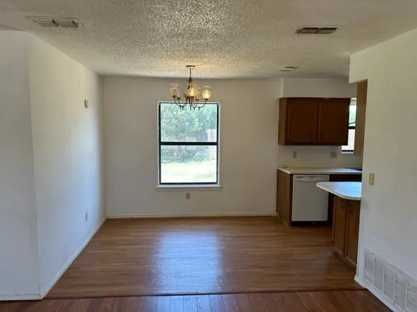 an empty room with a workspace and a window