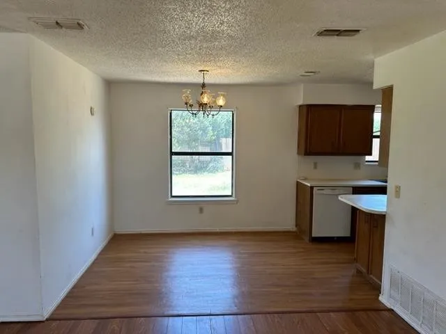 an empty room with a workspace and a window