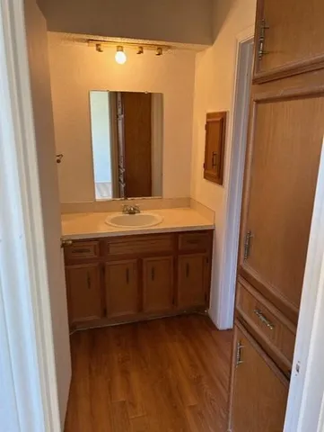 a bathroom with a granite countertop sink and a mirror