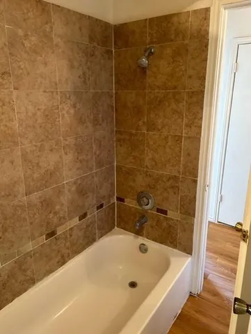 a bathroom with a bathtub and a shower