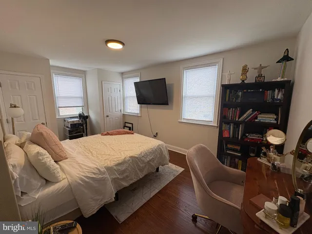 a bedroom with a bed and a television