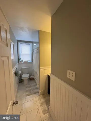 a bathroom with a sink toilet and a shower