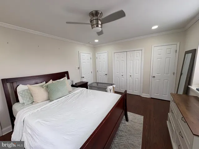 a bedroom with bed and a chandelier