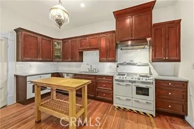 a kitchen with a stove and wooden cabinets