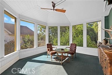 a living room with furniture and large windows