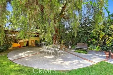 a view of a backyard with sitting area