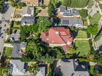 an aerial view of a house with garden space and street view