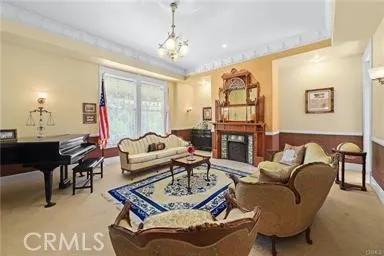 a living room with fireplace furniture and a chandelier