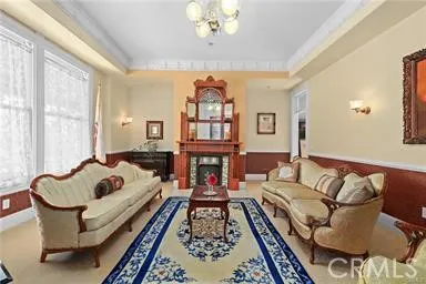 a living room with furniture ceiling fan and a window