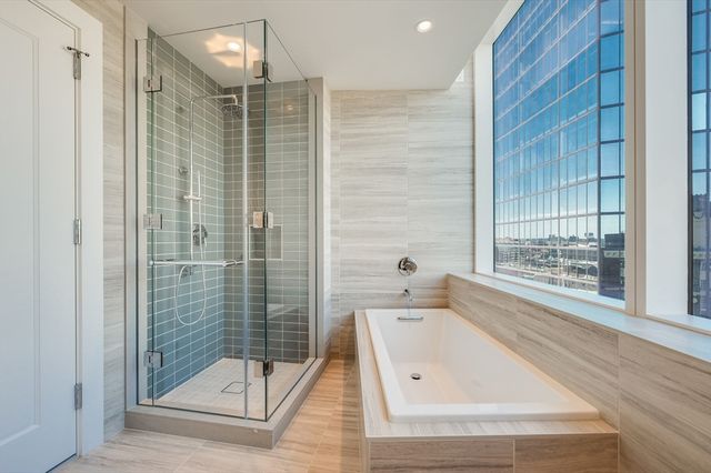 a bathroom with a shower and a bathtub