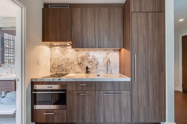 a kitchen with granite countertop a stove and a sink
