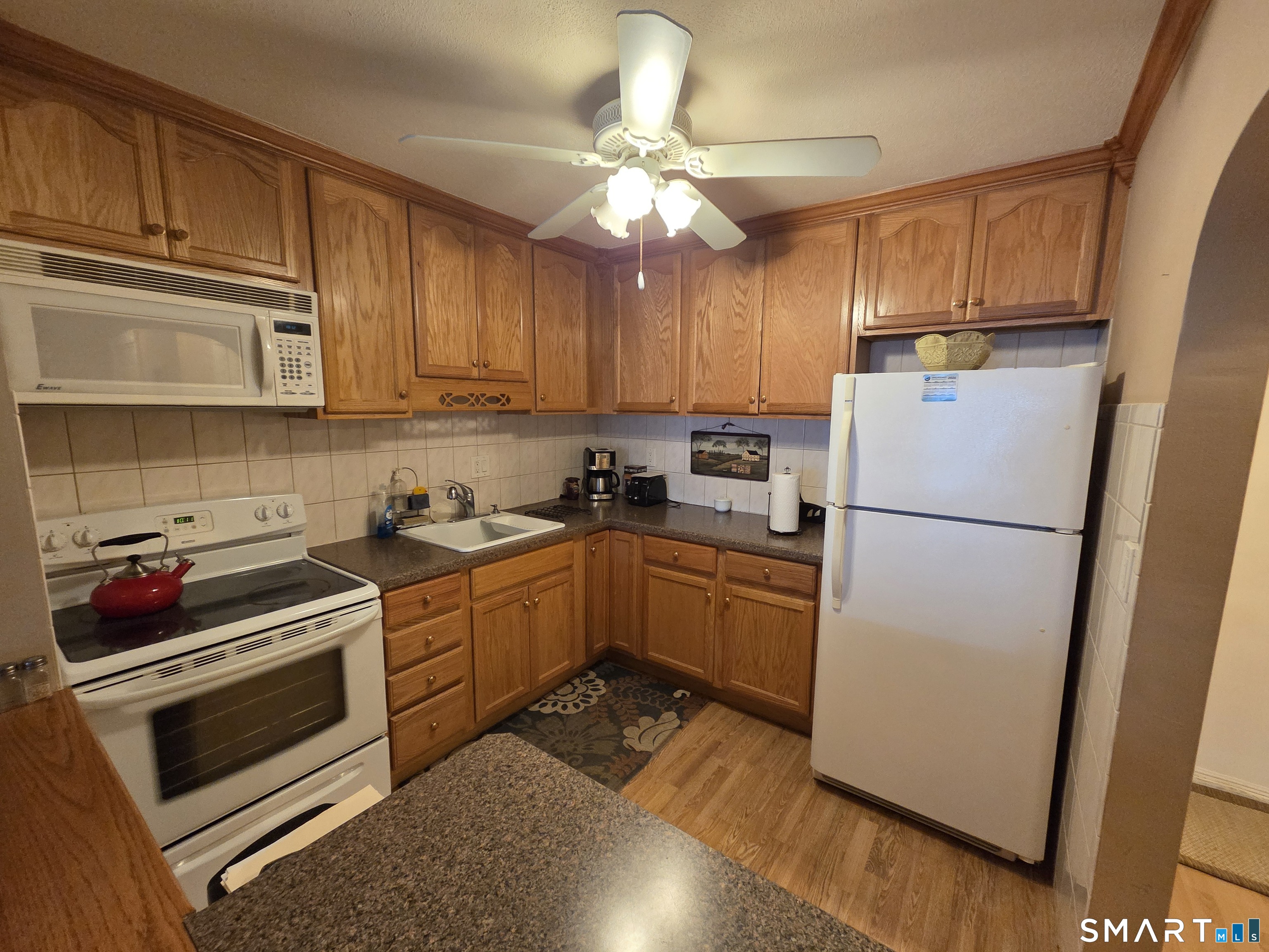 300 Meadowside Road, Unit 311 Milford, CT 06460 - Photo 1 of 7 a kitchen with a refrigerator sink and cabinets