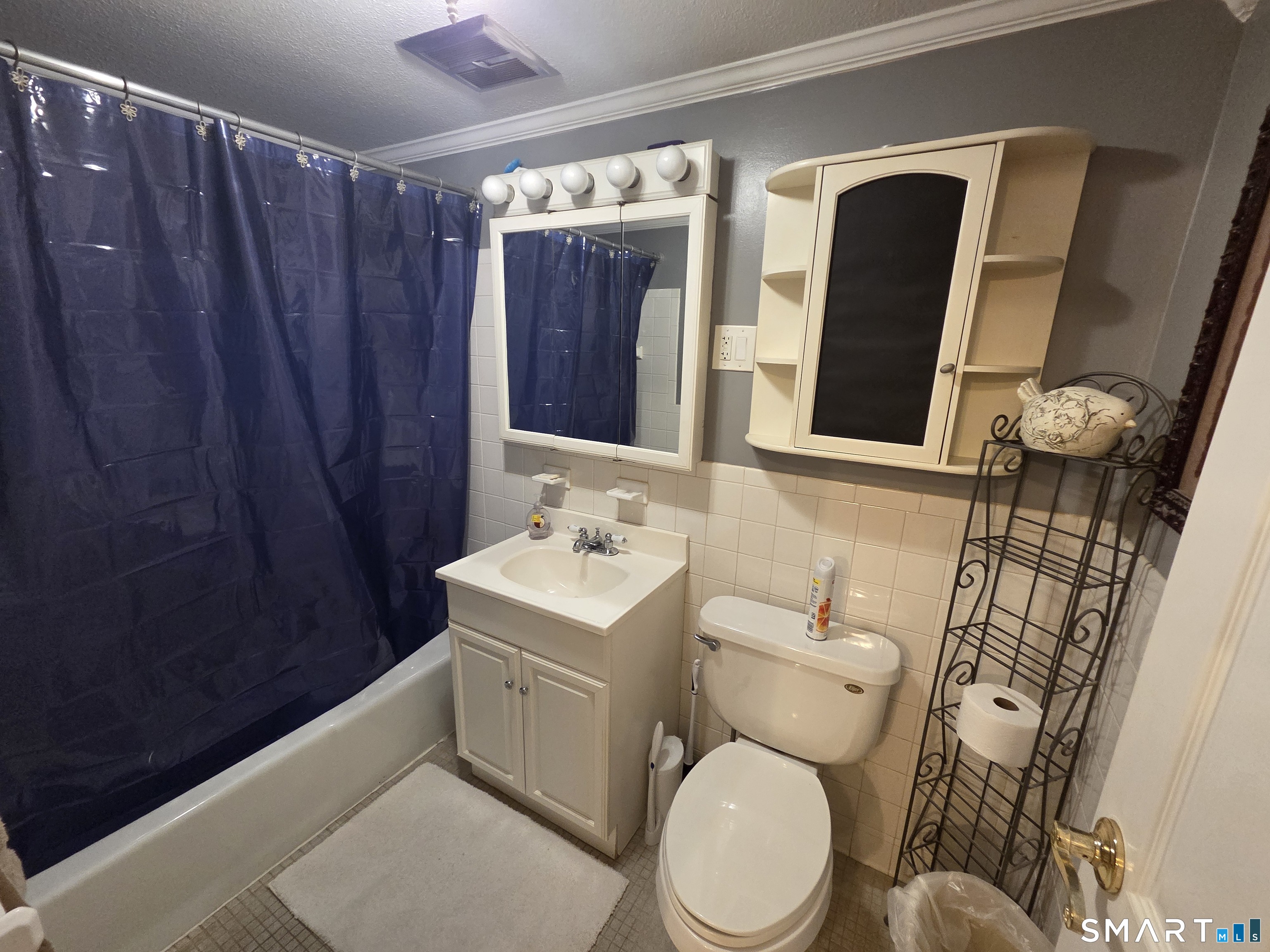 300 Meadowside Road, Unit 311 Milford, CT 06460 - Photo 6 of 7 a bathroom with a toilet a sink and a mirror