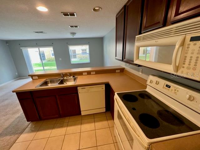 3896 Silverbell Loop Oviedo, FL 32765 - Photo 11 of 38 a kitchen with a stove sink and cabinets