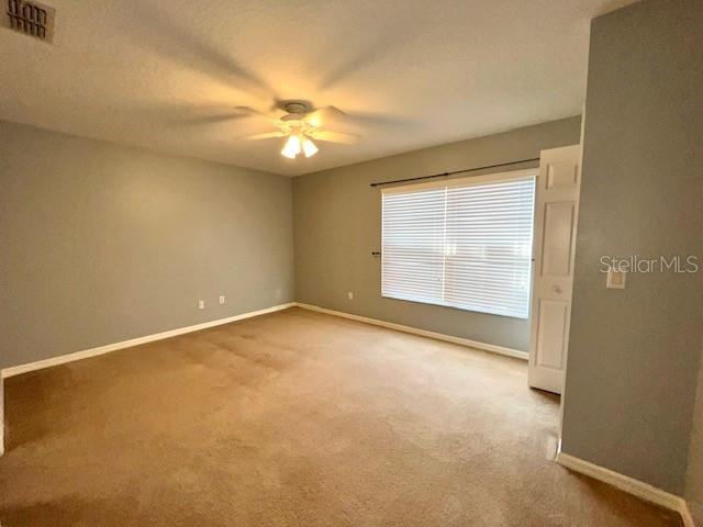 3896 Silverbell Loop Oviedo, FL 32765 - Photo 17 of 38 an empty room with windows and fan