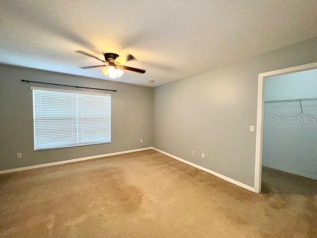 3896 Silverbell Loop Oviedo, FL 32765 - Photo 22 of 38 an empty room with a window and a ceiling fan