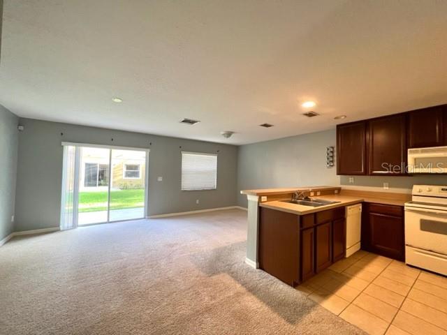 3896 Silverbell Loop Oviedo, FL 32765 - Photo 5 of 38 a view of a kitchen with kitchen island a sink a stove and a refrigerator