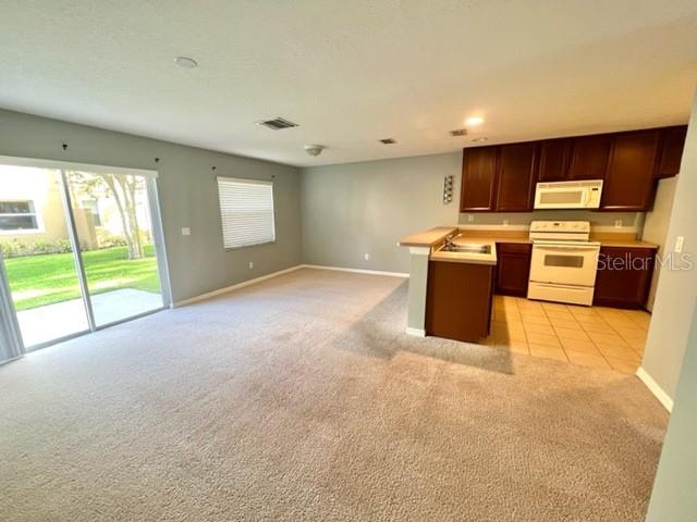 3896 Silverbell Loop Oviedo, FL 32765 - Photo 6 of 38 a view of a kitchen with a stove top oven