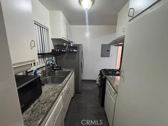 a kitchen with a sink stove and refrigerator