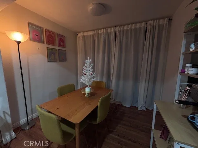 a view of a room with furniture and wooden floor