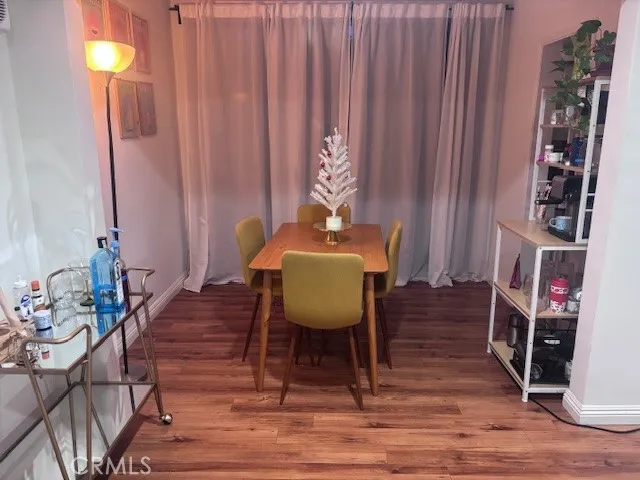 a dining room with furniture and wooden floor
