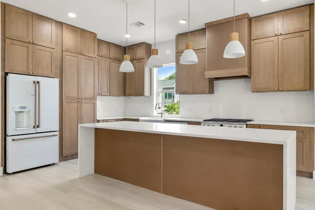 a view of an empty room with a fireplace and a window