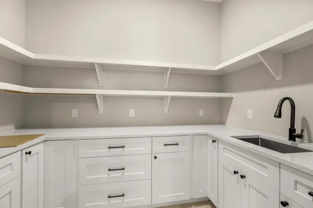 a view of a kitchen with a sink and a large window