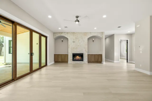 a spacious bathroom with a tub sink and mirror