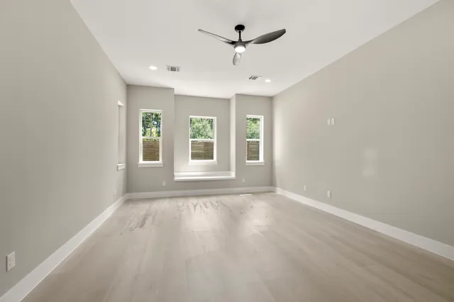 a spacious bathroom with double vanity a mirror and a shower