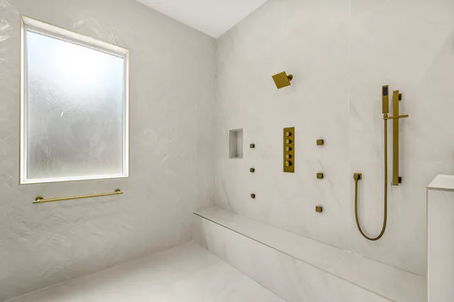 a view of a livingroom with a ceiling fan and window