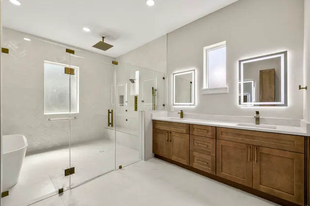 a bathroom with a sink a mirror and shower