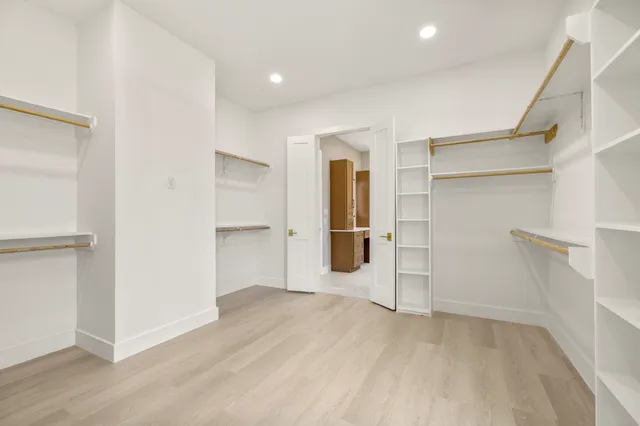 a bathroom with a granite countertop toilet sink and mirror