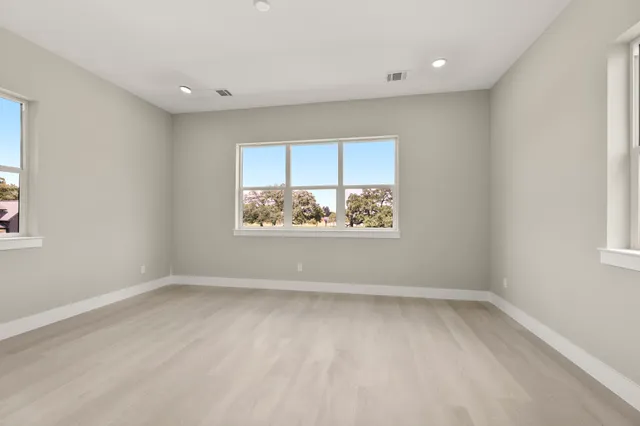 wooden floor in an empty room with a window