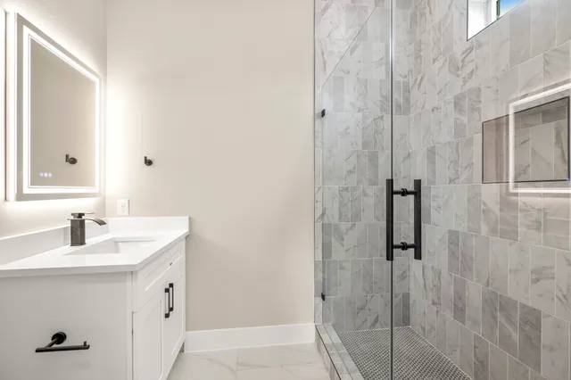 a view of a room with wooden floor and a ceiling fan