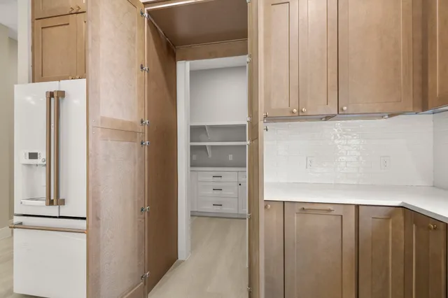 a kitchen with a stove a oven a counter space and living room view