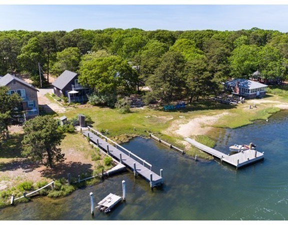 an aerial view of a house with a yard and lake view