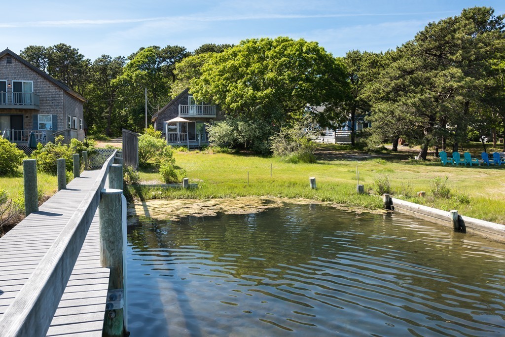 23 Riverside Road Mashpee, MA 02649 - Photo 3 of 19 a view of a swimming pool with a patio