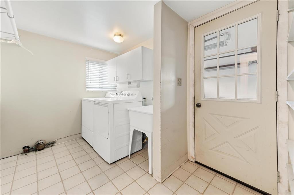 132 Shafer Road Moon Township, PA 15108 - Photo 13 of 15 a utility room with cabinets washer and dryer