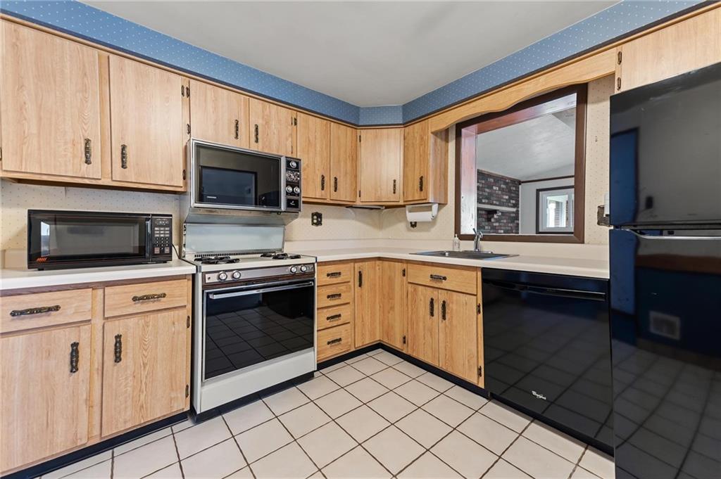 132 Shafer Road Moon Township, PA 15108 - Photo 4 of 15 a kitchen with granite countertop white cabinets a sink and stainless steel appliances