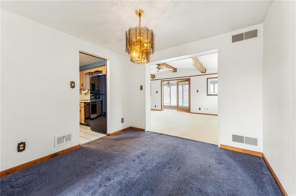 132 Shafer Road Moon Township, PA 15108 - Photo 6 of 15 an empty room with chandelier fan and windows