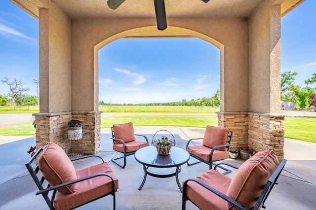 a bedroom with bed a flat tv screen and dresser