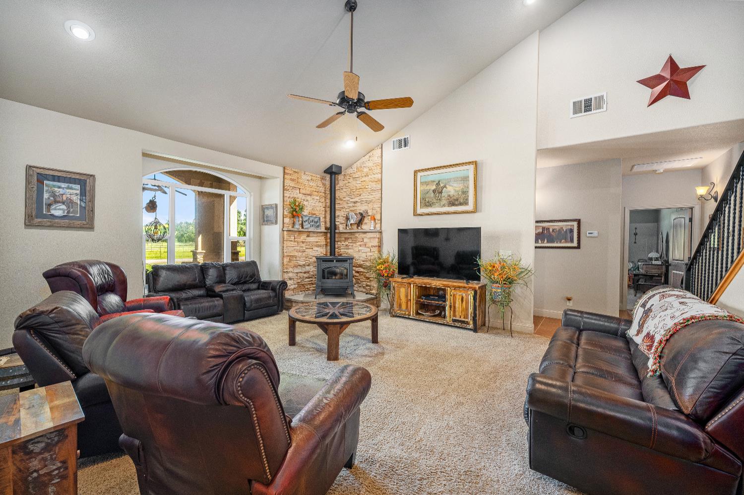 15605 Johnson Road Red Bluff, CA 96080 - Photo 18 of 88 a living room with furniture a flat screen tv and a fireplace